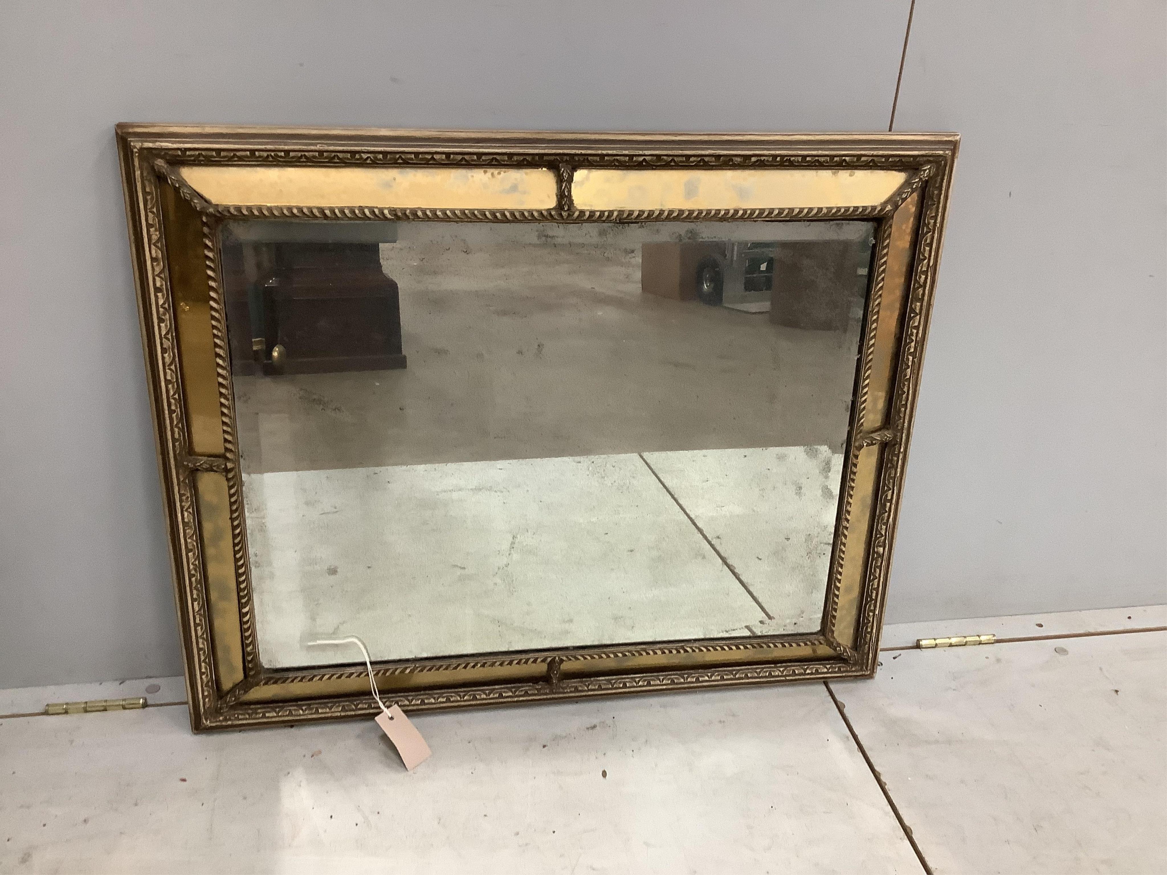 A pair of Regency style rectangular giltwood and composition marginal plate cushion framed mirrors, width 66cm, height 83cm. Condition - fair to good